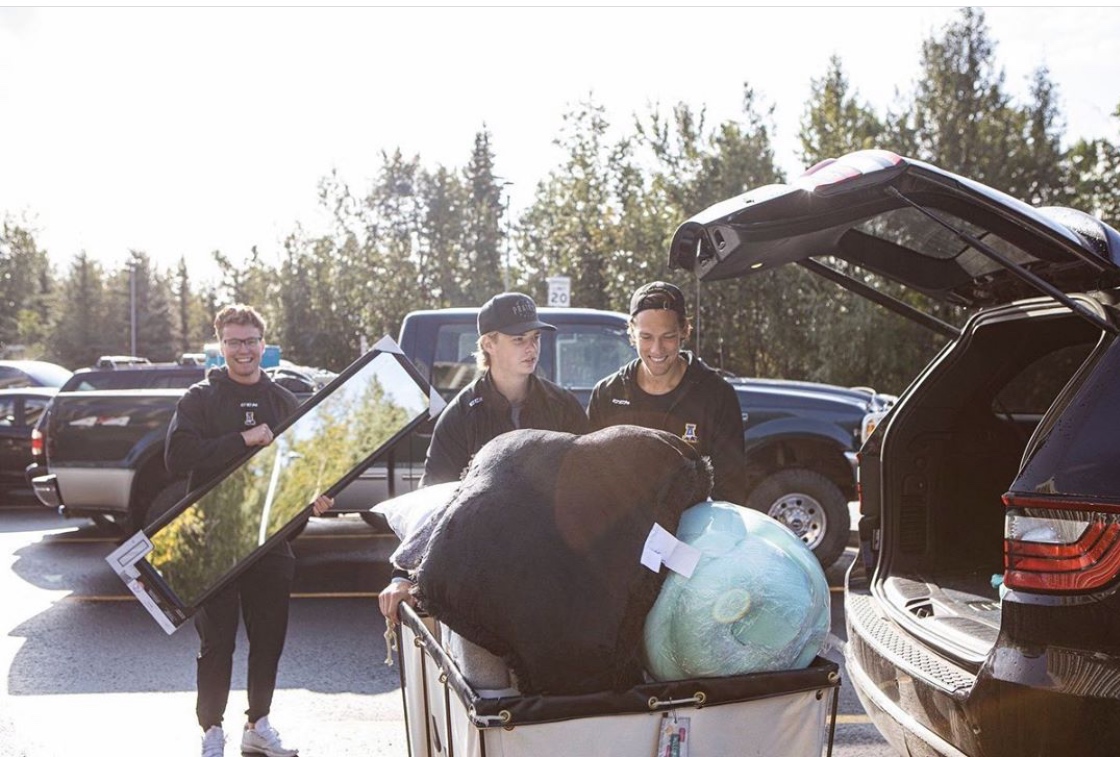 three college students move into dorm
