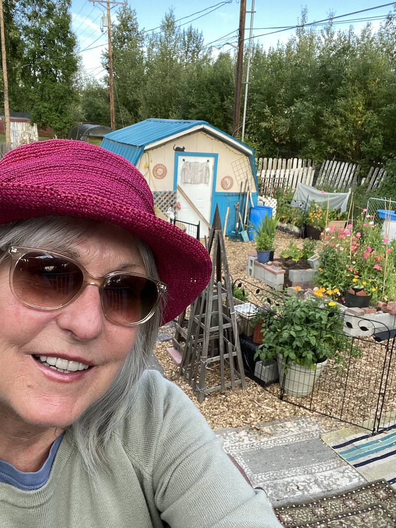 Lady smiles in selfie in her garden 