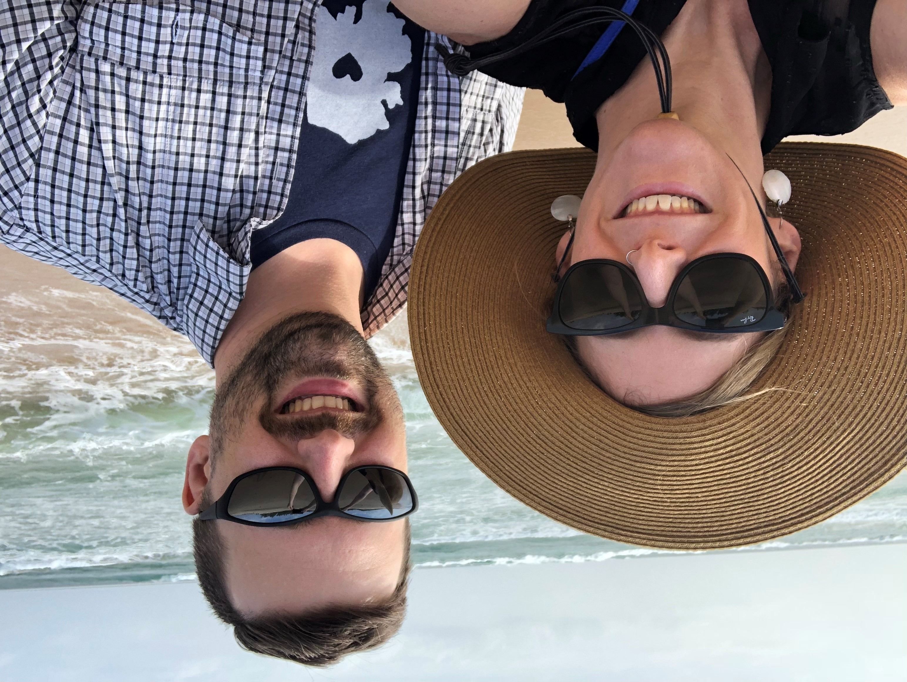 husband and wife take selfie on the beach
