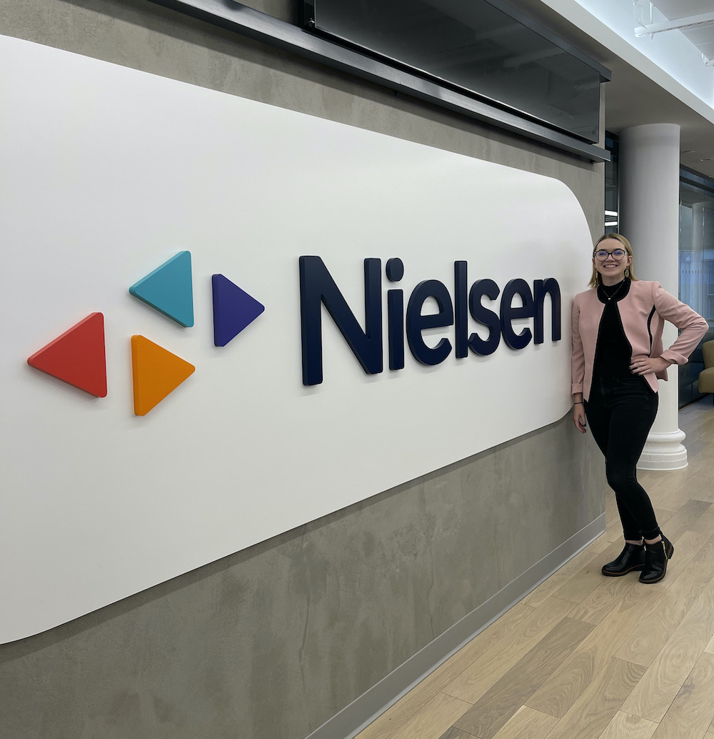 woman stands in lobby of Neilson building