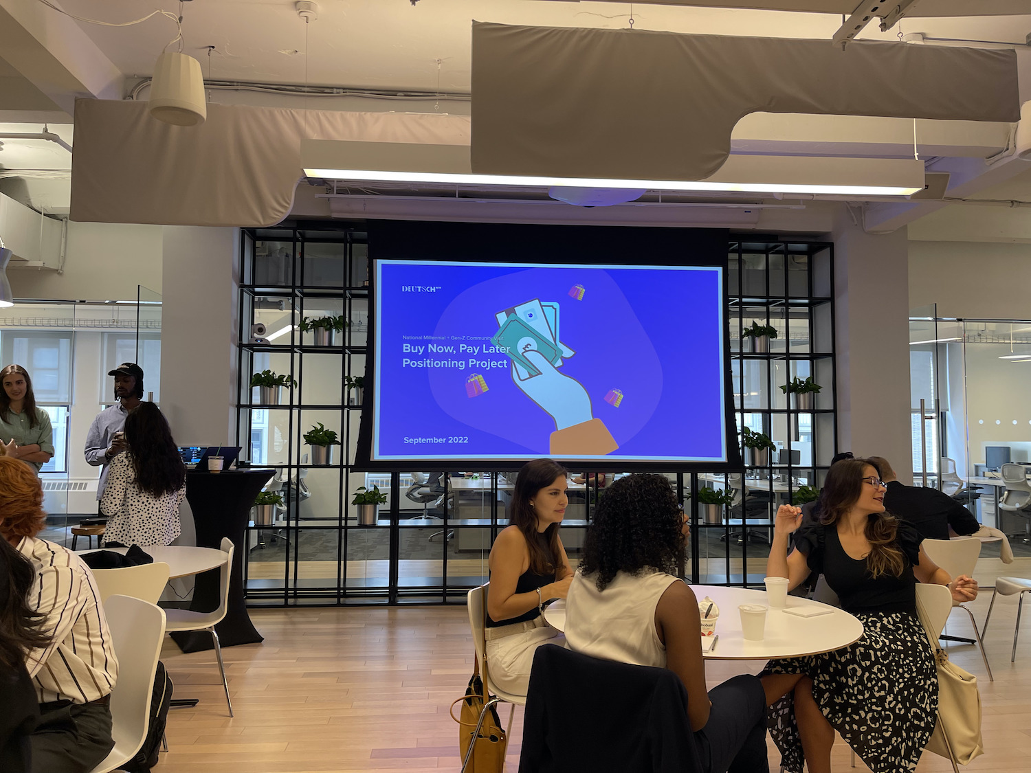 conference room with a table of students and presentation board