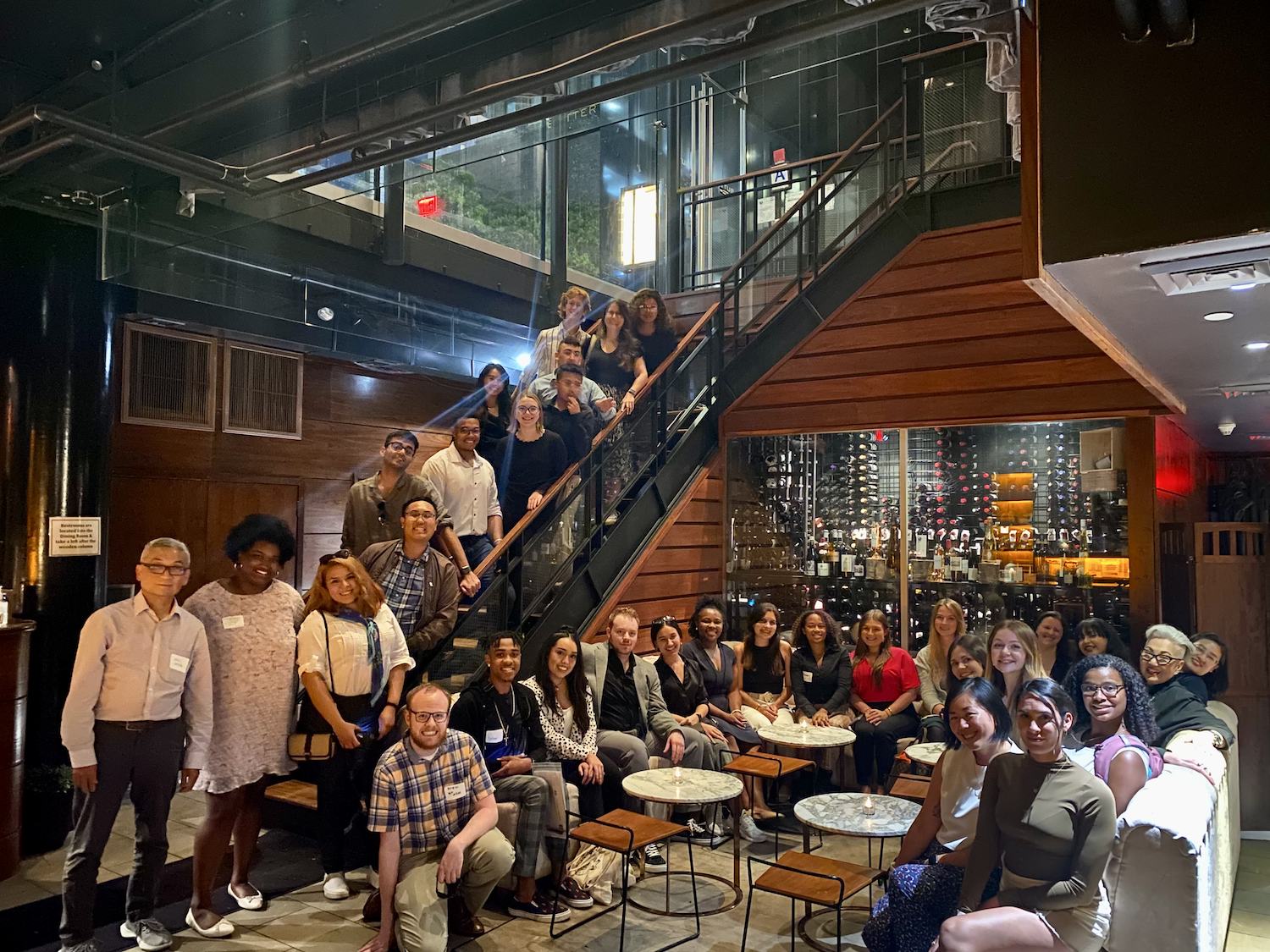 Big group photo in dim light restaurant