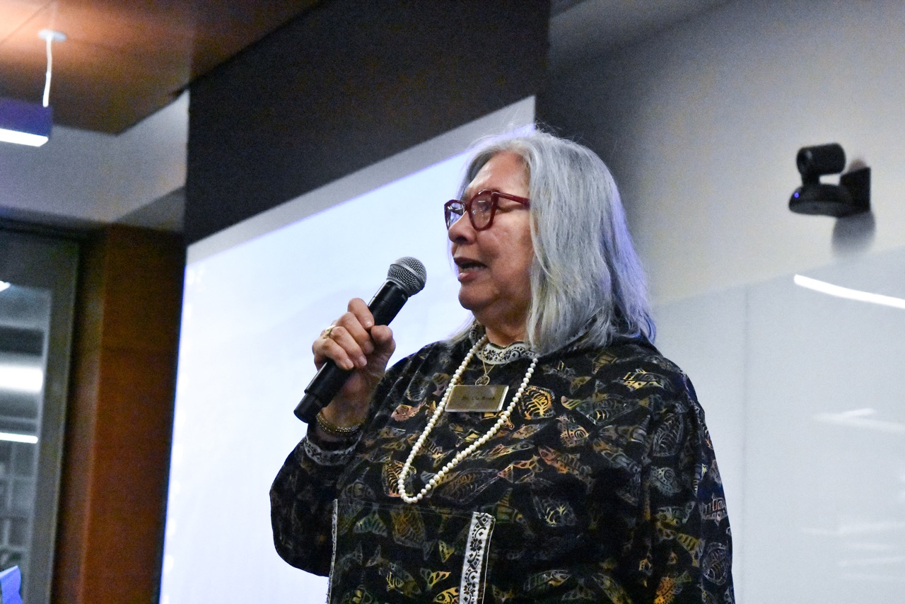 woman speaks into a microphone