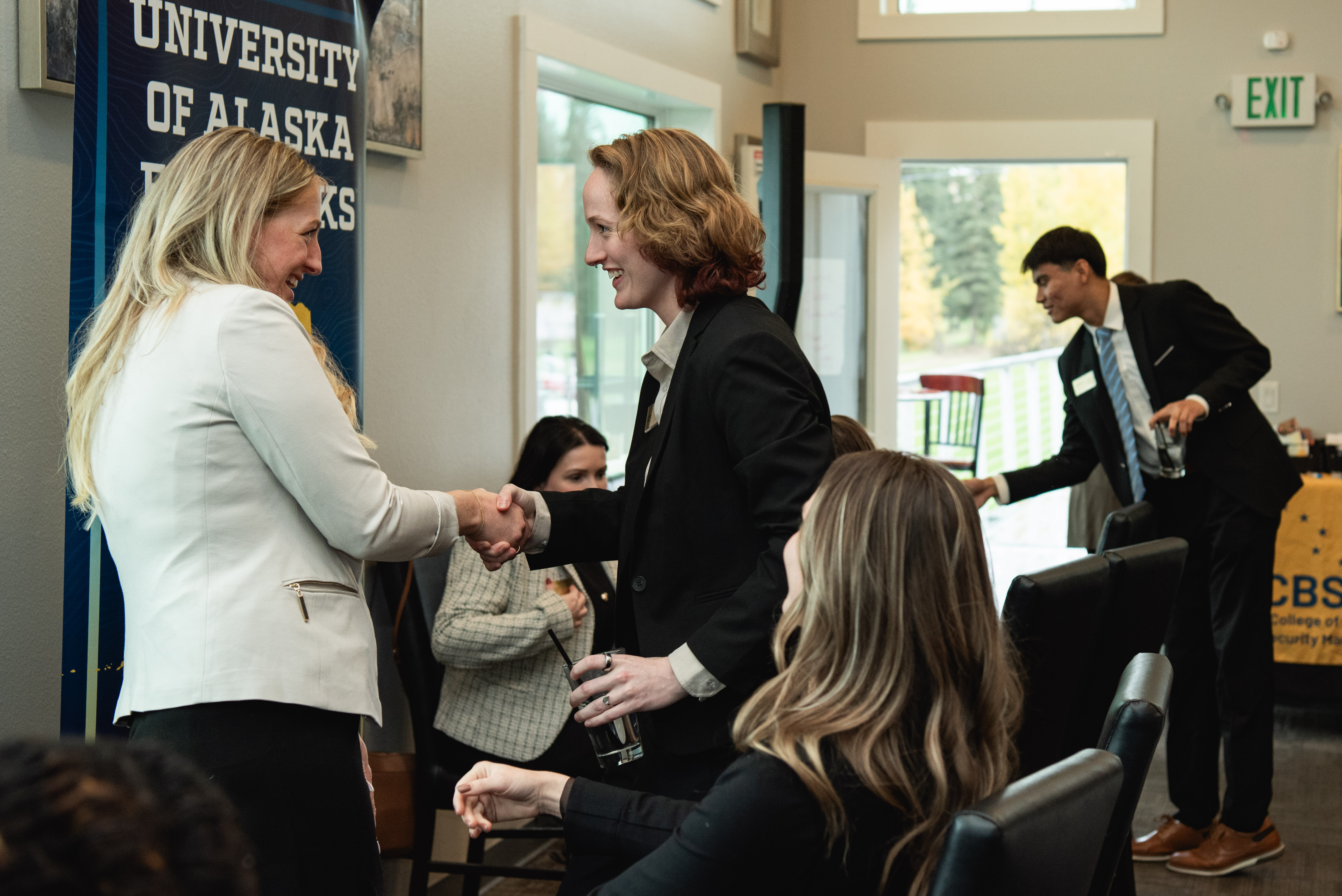 CBSM Student Shaking hands with KPMG recruiter, Melissa Jay.