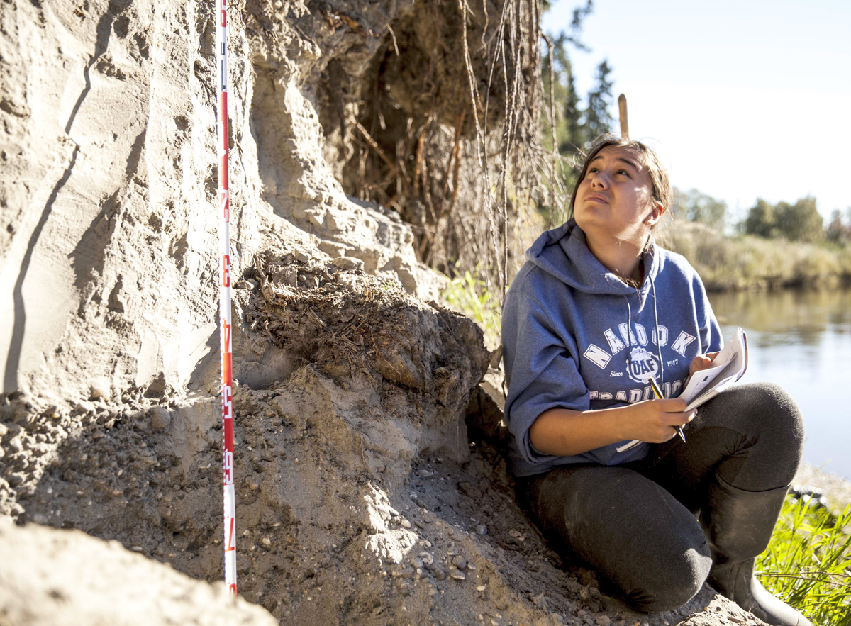 Student working in rock outcrop