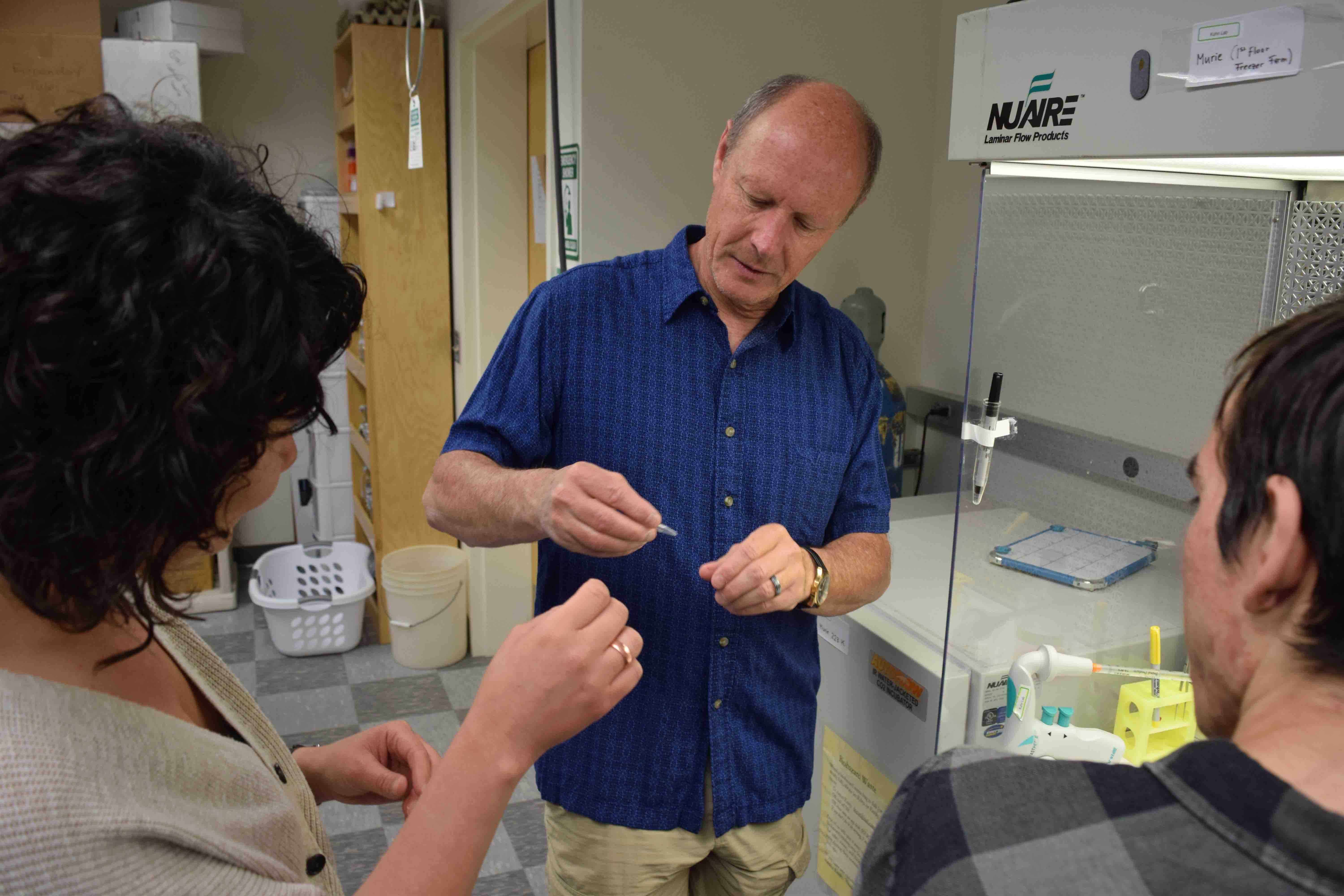 Dr. Thomas Kuhn shows students a sample in his lab. Photo by Amy Topkok/BLAST