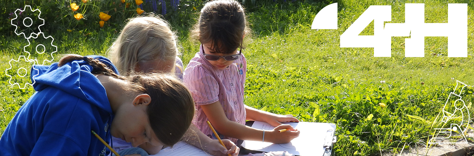 Children observing and making notes in a garden