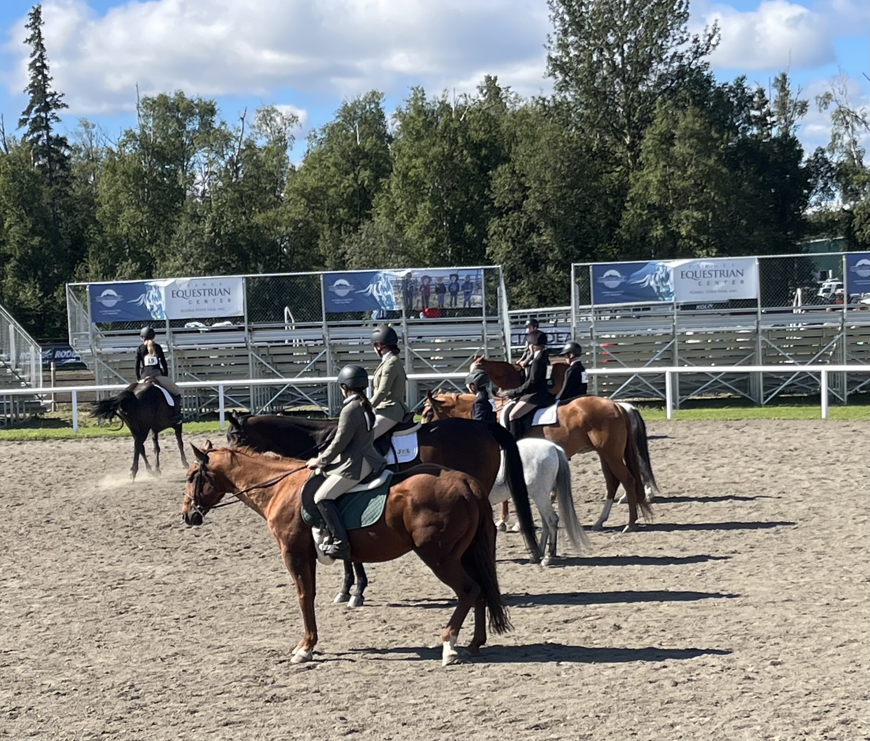 Row of horse and rider awaiting their turn for the state horse competion