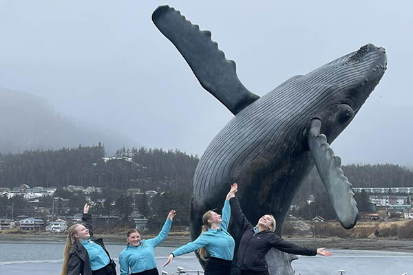 4-H youth in front of whale sculpture