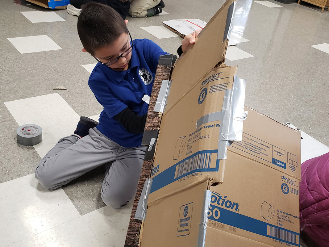 Student working on cardboard project