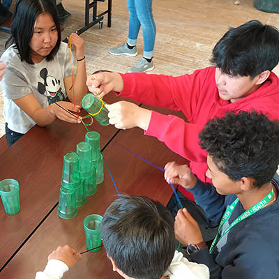 Group of kids playing a game with green cups