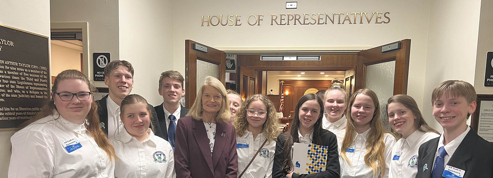 Group of people standing in front of house of representatives