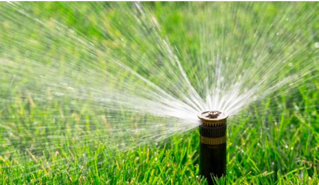 Sprinkler Tool spraying water upwards onto grass