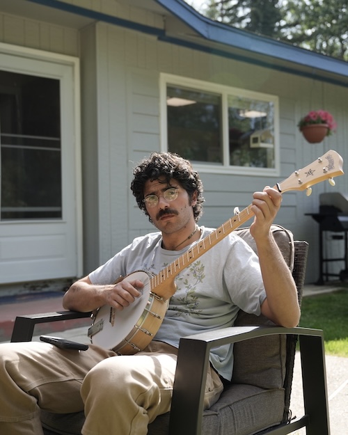 Photo of Sohrab playing on a banjo