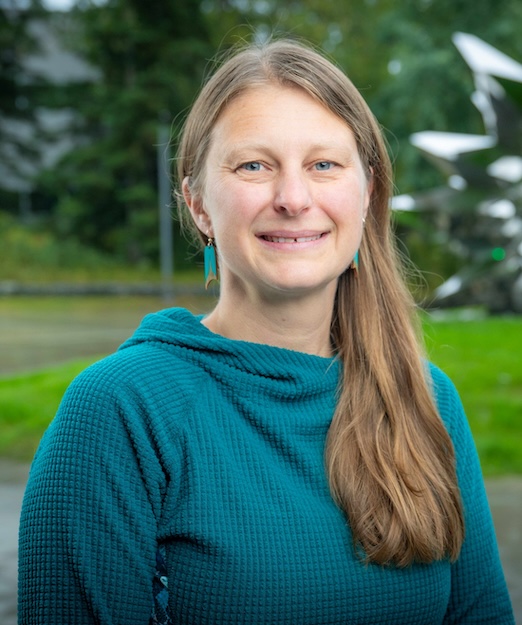 Natalie Rouse smiling with trees in the background