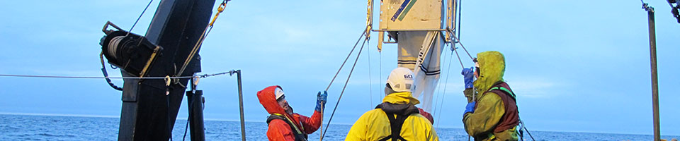 UAF students handling equipment on research vessel