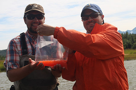 Researchers holding a bag of roe