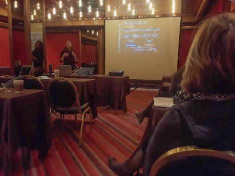 Photo of Cheryl Barnes speaking to her audience at the symposium