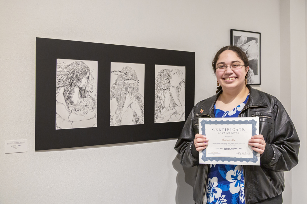 Kainoa Ake with her 1st place award-winning drawing, "Mother, Friend, and Me". UAF Photo by Sarah Manriquez