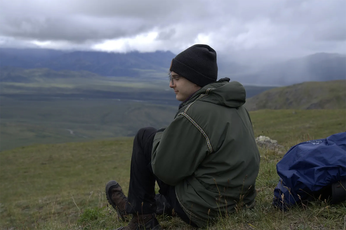 Seamus Knight pauses on a mountainside in Denali National Park during the Composing in the Wilderness residency. Photo courtesy of Knight