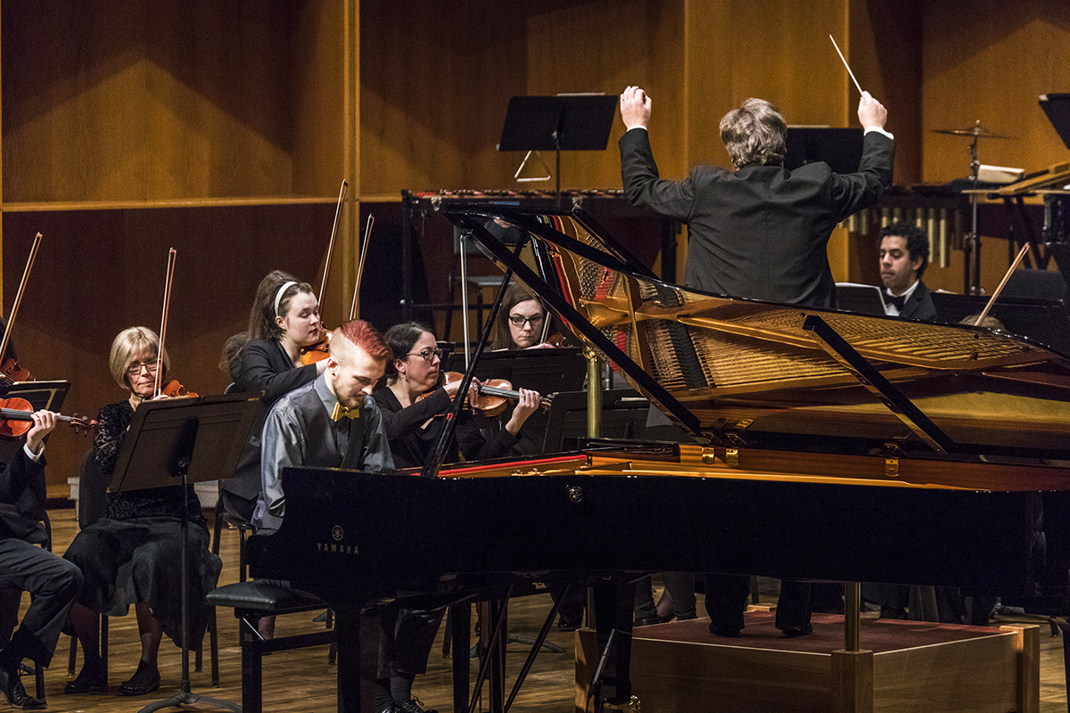 Scott Hansen composed and played the piano for the UAF Centennial Overture, alongside the Fairbanks Symphony Orchestra, conducted by Eduard Zilberkant. UAF Photo by JR Ancheta