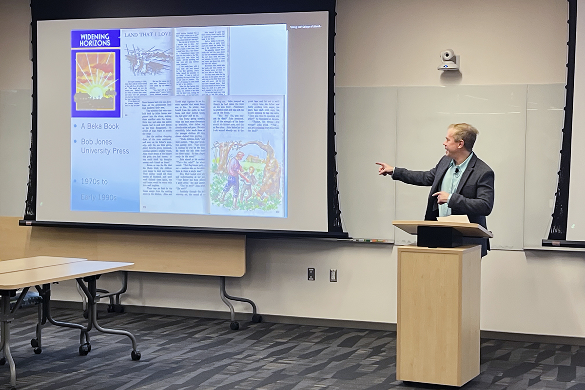 Neall Pogue highlights historical materials and examples from his research during the talk. UAF Photo by Sarah Manriquez