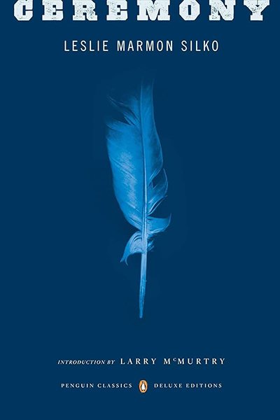 Cover of "Ceremony" by Leslie Marmon Silko. Dark blue with a light blue feather.