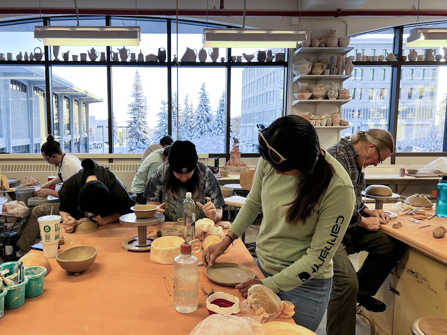 Ceramic artists work on their bowls in the UAF Ceramics Studio during SCAG's Empty Bowls event. Photo courtesy of Olena Ellis.
