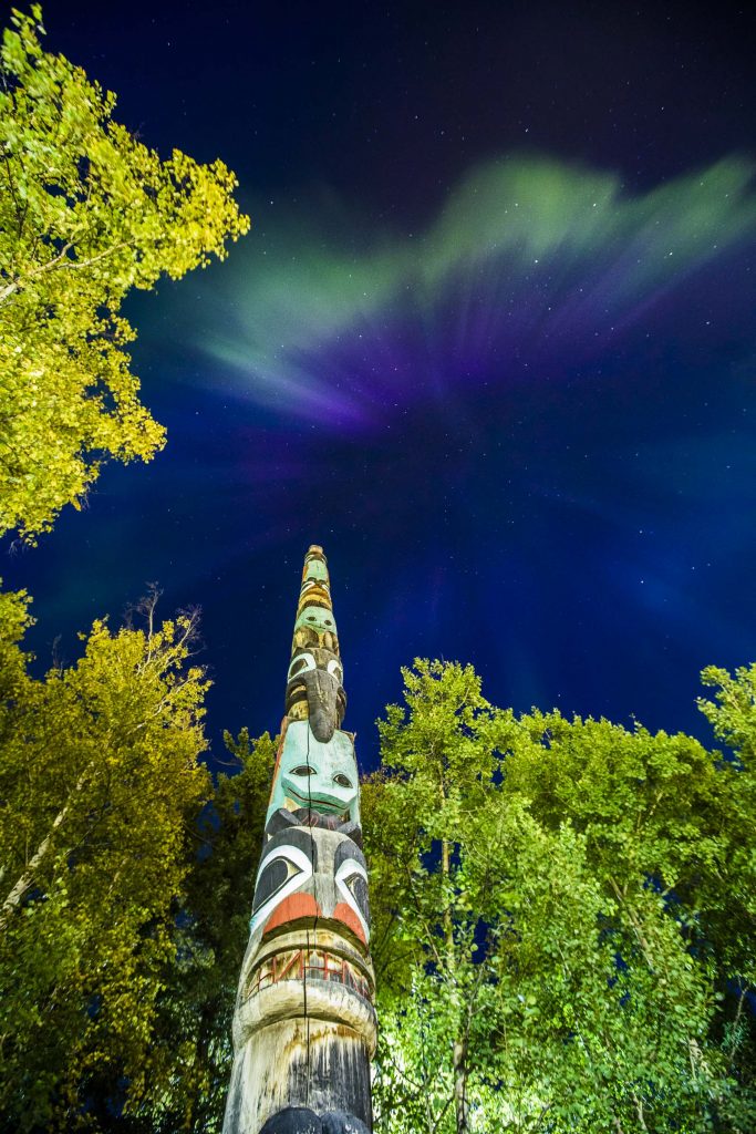 UAF photo by JR Ancheta. A vivid display of the aurora is seen above the UA Museum of the North, on the Fairbanks campus, before the start of the fall semester. The Wolf Totem Pole: Everyone’s Grandfather, by Nathan Jackson and Amos Wallace, is part of the museum’s outdoor exhibits.