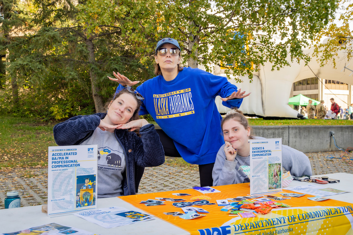 (left to right) Department of Communications faculty, Nike Jacob, Dr. Amy May and Dr. Victoria McDermott take a photo together while attending the Party in the Park on the lower Troth Yeddha' Campus, Sep. 3, 2024. (UAF photo by Leif Van Cise)