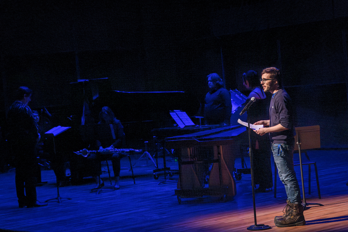 UAF English MFA student Manuel Melendez reads a poem on stage at the Circumpolar Music Series event held on February 21st, 2025.