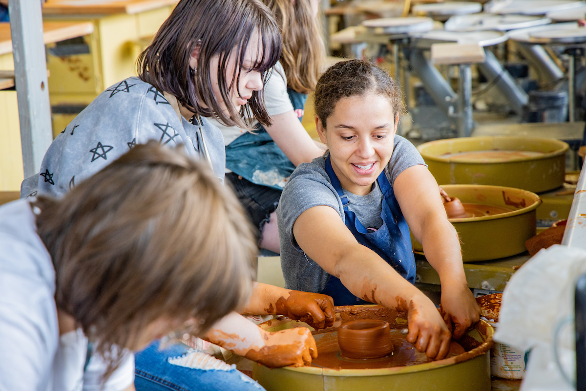 Instructor Shaylise Sylvester helps a student with her ceramic piece at the 2024 Summer Visual Arts Academy on Wednesday, June 12, 2024. UAF Photo by Marina Barbosa Santos