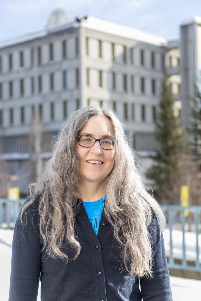 Jennifer Schell, with UAF's Gruening Building in the background. UAF Photo by Sarah Manriquez