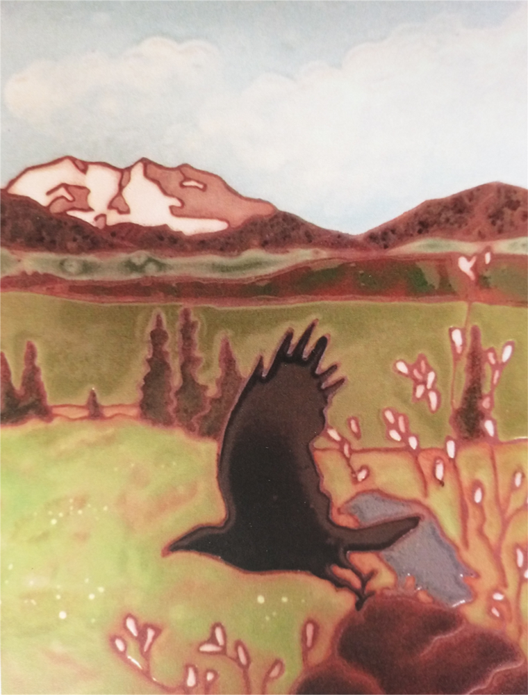 Ceramic tile of a rave with outstretched wings, flying over green grass with white Denali in the background. Art by Nancy Hausle-Johnson