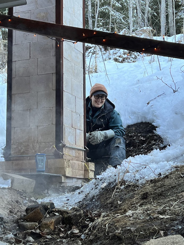 Amy Edler tends the wood kiln during a wood firing in April 2025. Photo courtesy of the UAF Department of Art.