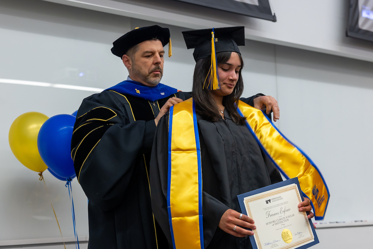 Francie Eufemio receives her Honors College stole during the UAF Honors College graduation ceremony in May 2026. UAF Photo by Eric Engman