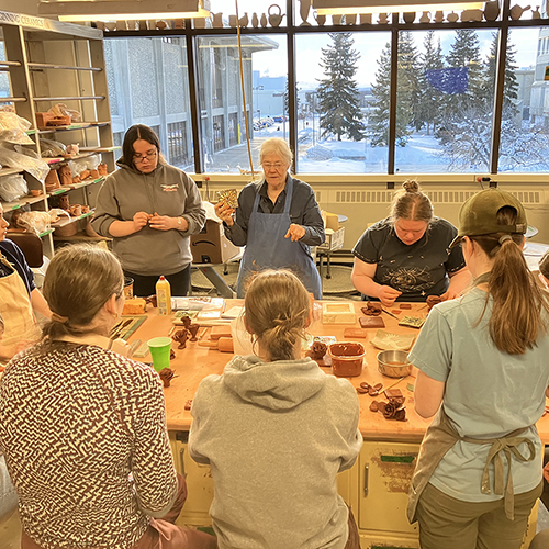 Ceramic artist Nancy Hausle-Johnson leads a hands-on workshop, sharing tile-making techniques and insights from her decades of practice. Photo courtesy of Teresa Shannon