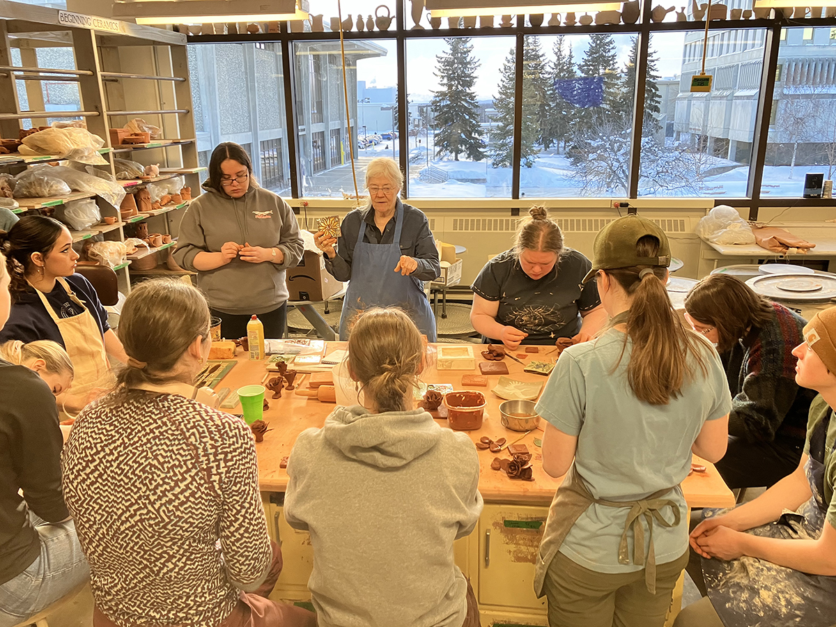 Ceramic artist Nancy Hausle-Johnson leads a hands-on workshop in the UAF Ceramics Studio.