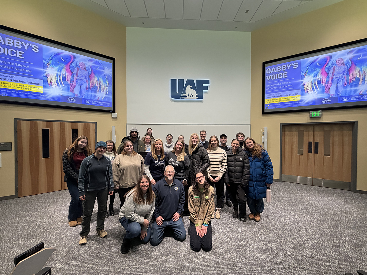 Students, faculty and staff from the UAF Department of Justice gather with speakers Nichole Schmidt and Tara Petito following their presentation on domestic violence awareness and prevention. UAF Photo by Sarah Manriquez