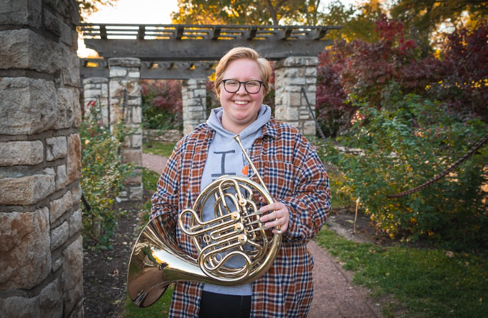 Award recipient Beatrice Turley poses for a photo holding her French horn