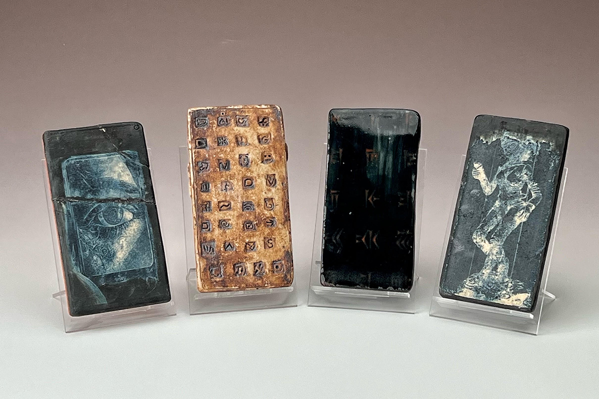Future’s Calling (Phone Quartet): Paleo Screenshot {1 & 2}, handbuilt ceramic stoneware, laser engraving, AI-generated images Photo courtesy of Nick Dwyer