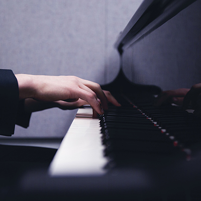 Hands playing the piano