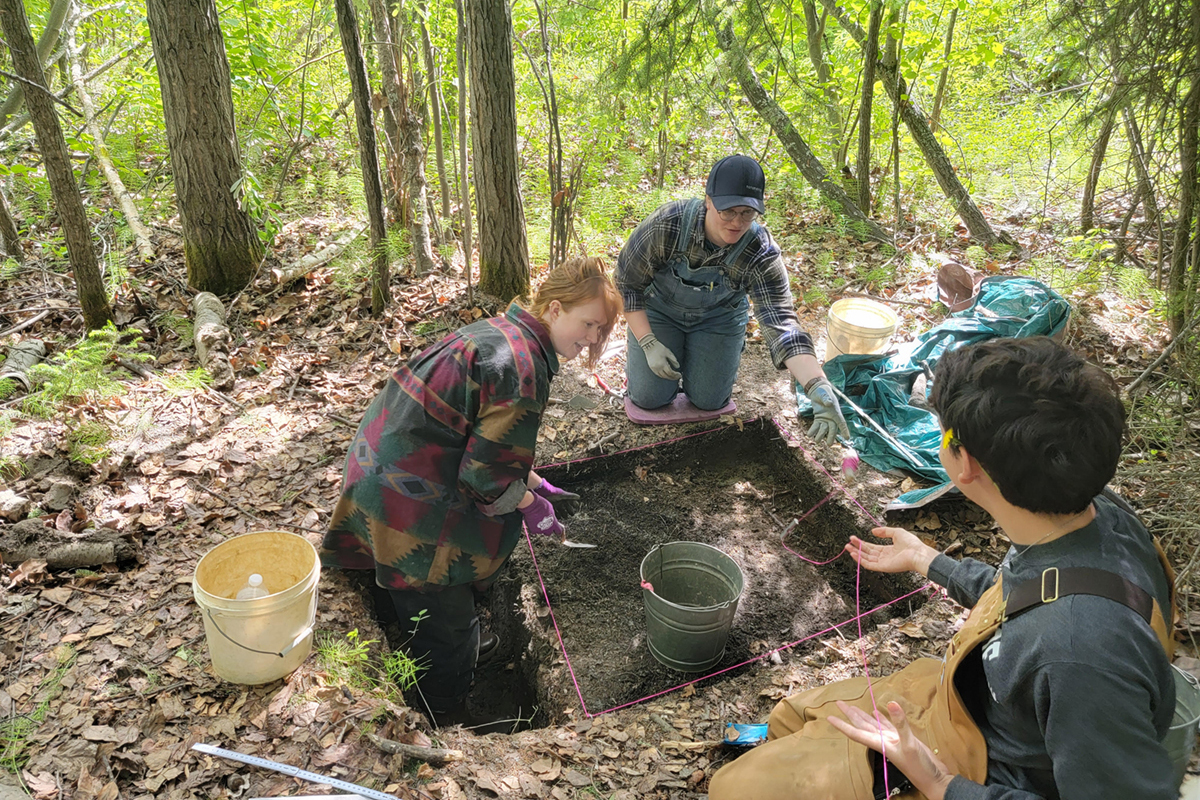 Archeology researchers Meredith McMahon (left), Jack Helmericks (middle) and Josh Reiff excavate a privy in 2023 at the Chena Townsite. Photo courtesy of Justin Cramb