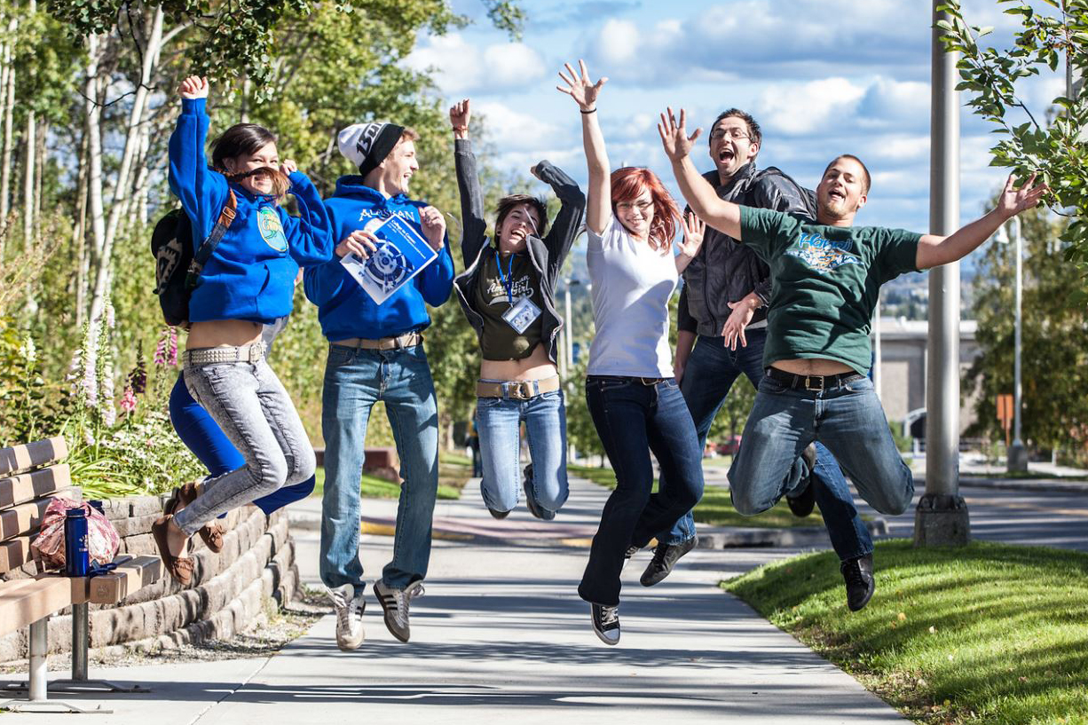 New students on campus jump for a photograph on their way to the MBS complex Tuesday afternoon, August 28, 2012.