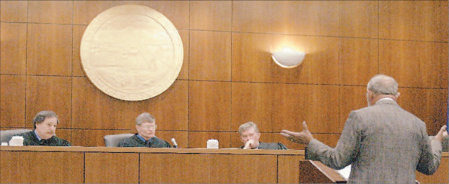 Attorney Dick Madson addresses the Alaska Court of Appeals on May 6, 2003, in the Rabinowitz Courthouse in Fairbanks. Madson failed to persuade the panel that his client, Marvin Roberts, deserves a new trial. From left are Judge David Mannheimer, Chief Judge Robert Coats and Judge David Stewart.