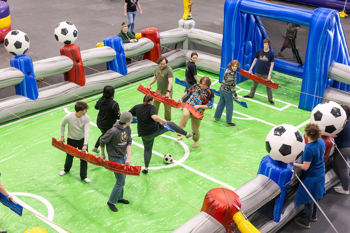 Attendees enjoy romping on inflatable game stations during Nanook Traditions 2025 Springfest in the Student Recreation Center on the UAF campus Saturday afternoon, April 19, 2025. UAF Photo by Eric Engman
