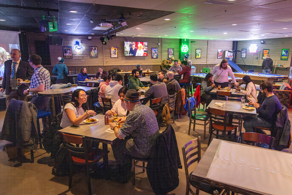 UAF graduate school students meet with peers, staff and faculty during their spring social at The Pub on campus, Friday, January 10, 2025. (UAF photo by Leif Van Cise)