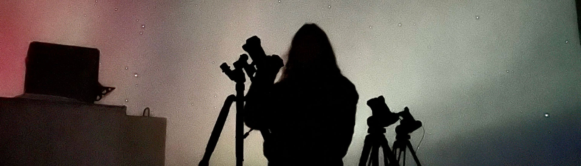 A sillouette of a person photographing the aurora at Poker Flat Research Range