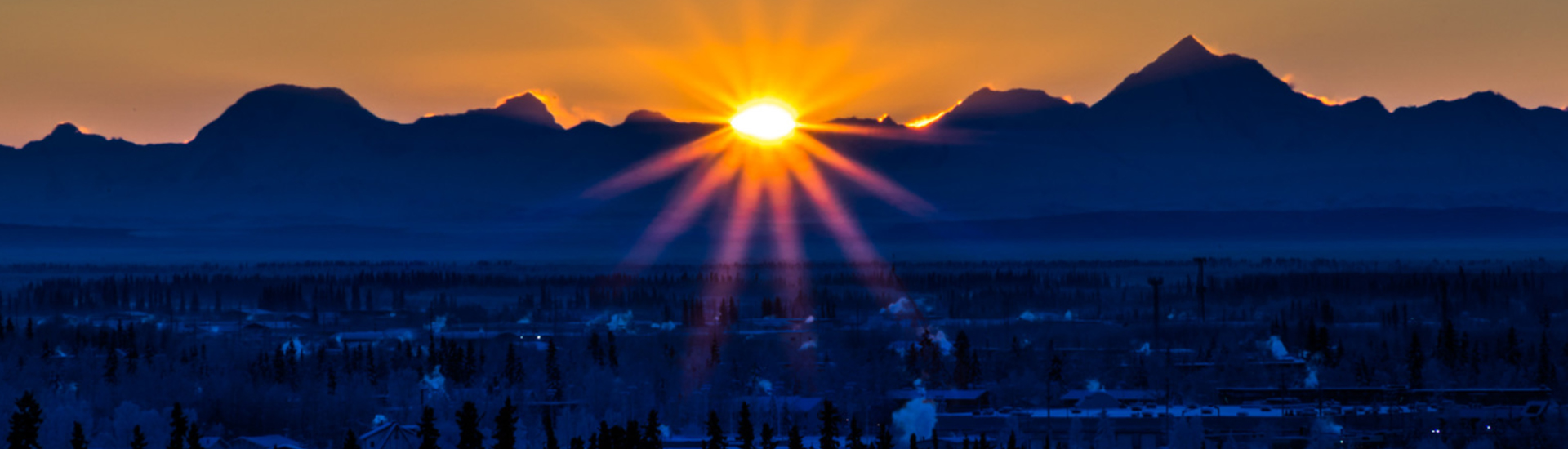 sun and mountains in winter