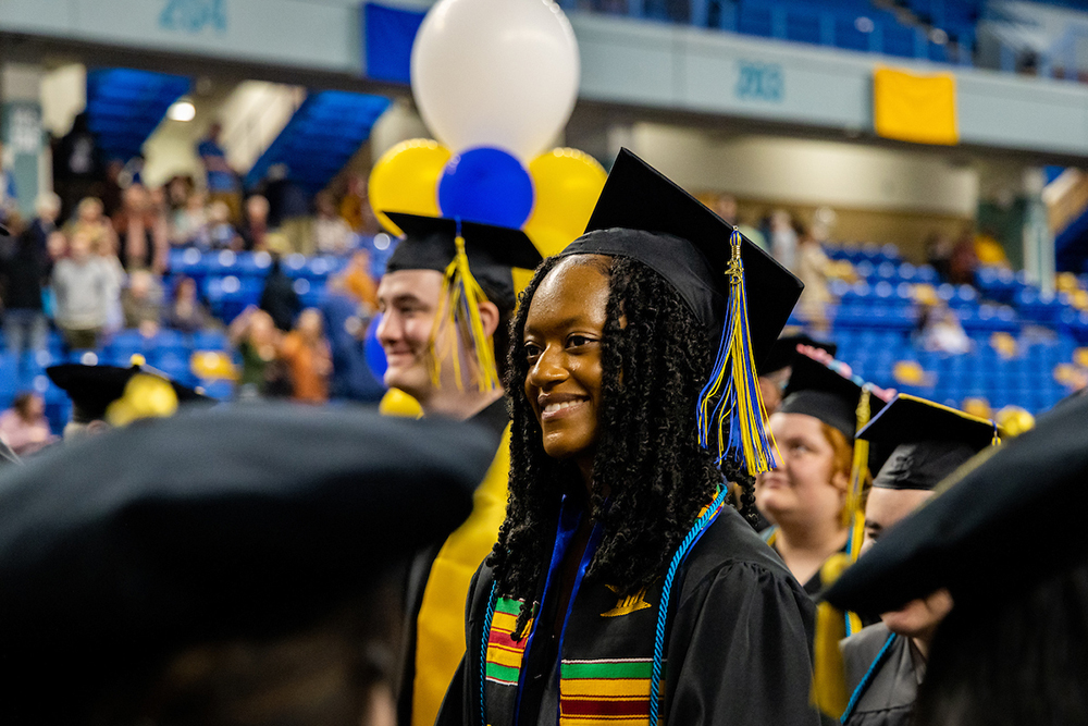 Student athlete and B.A. of Communications, Samaiyah Tolliver, walks among fellow graduates amidst the closing ceremony of UAF's 2023 Commencement hosted at the Carlson Centers, 5/6/23. (UAF photo by Leif Van Cise)